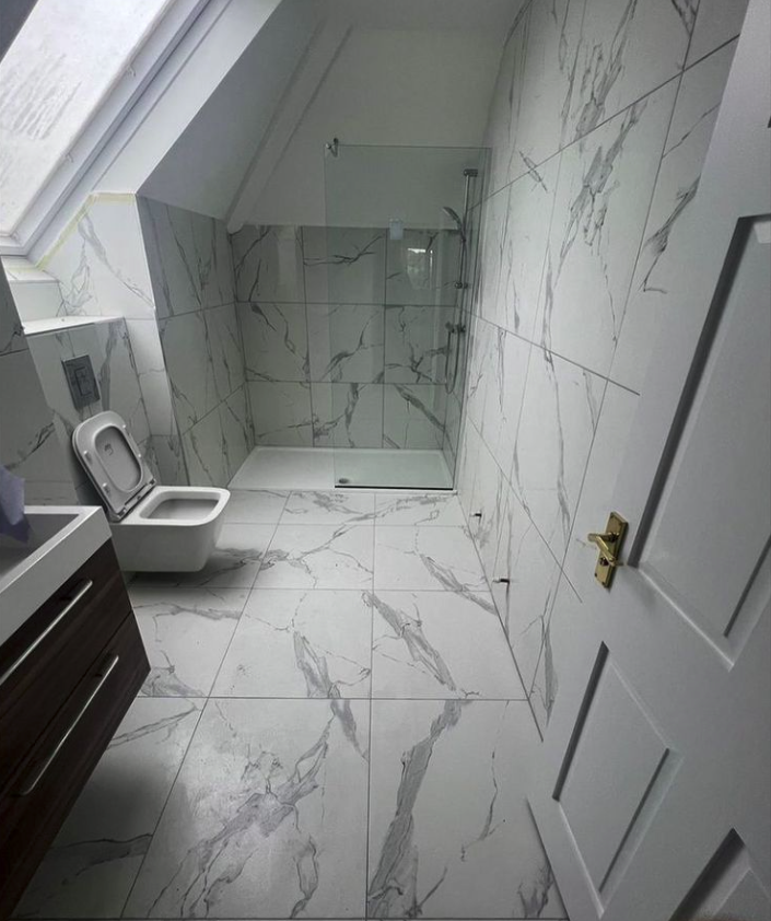 Fully tiled bathroom with shower tray by Ben Tiling Hertfordshire